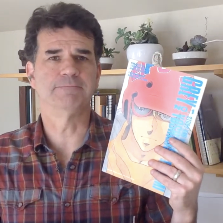 Nick Mullins holding up issue one of Grey